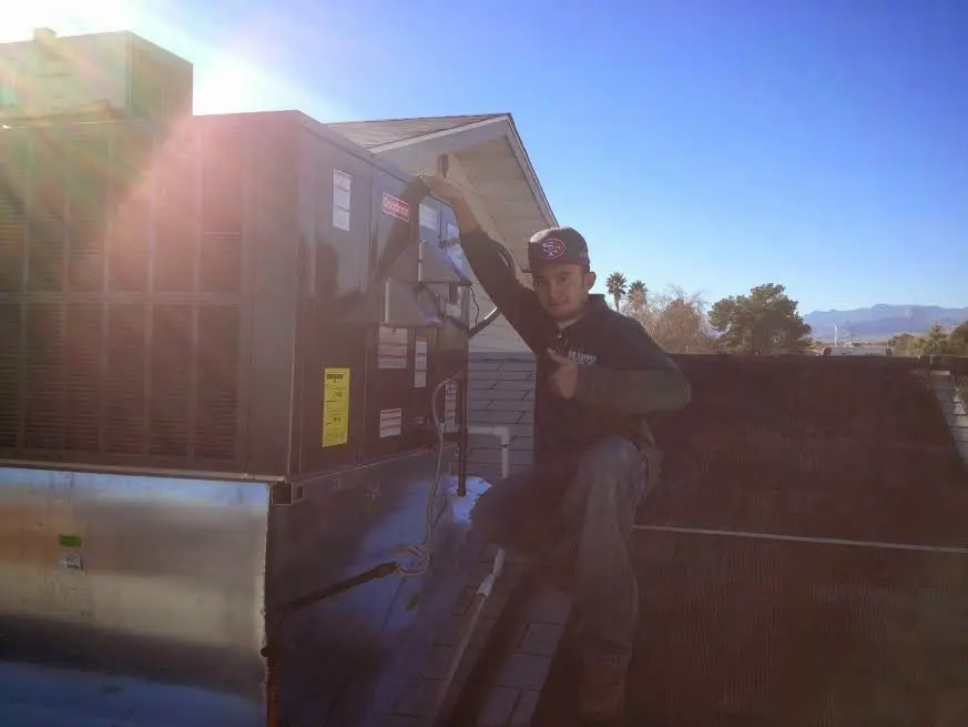 HVAC technician performing AC Tune-Up on a rooftop unit in Dublin